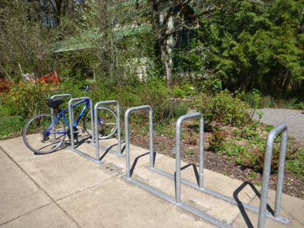 Bike rack at the nature center plaza - gravel path through native plants - restrooms